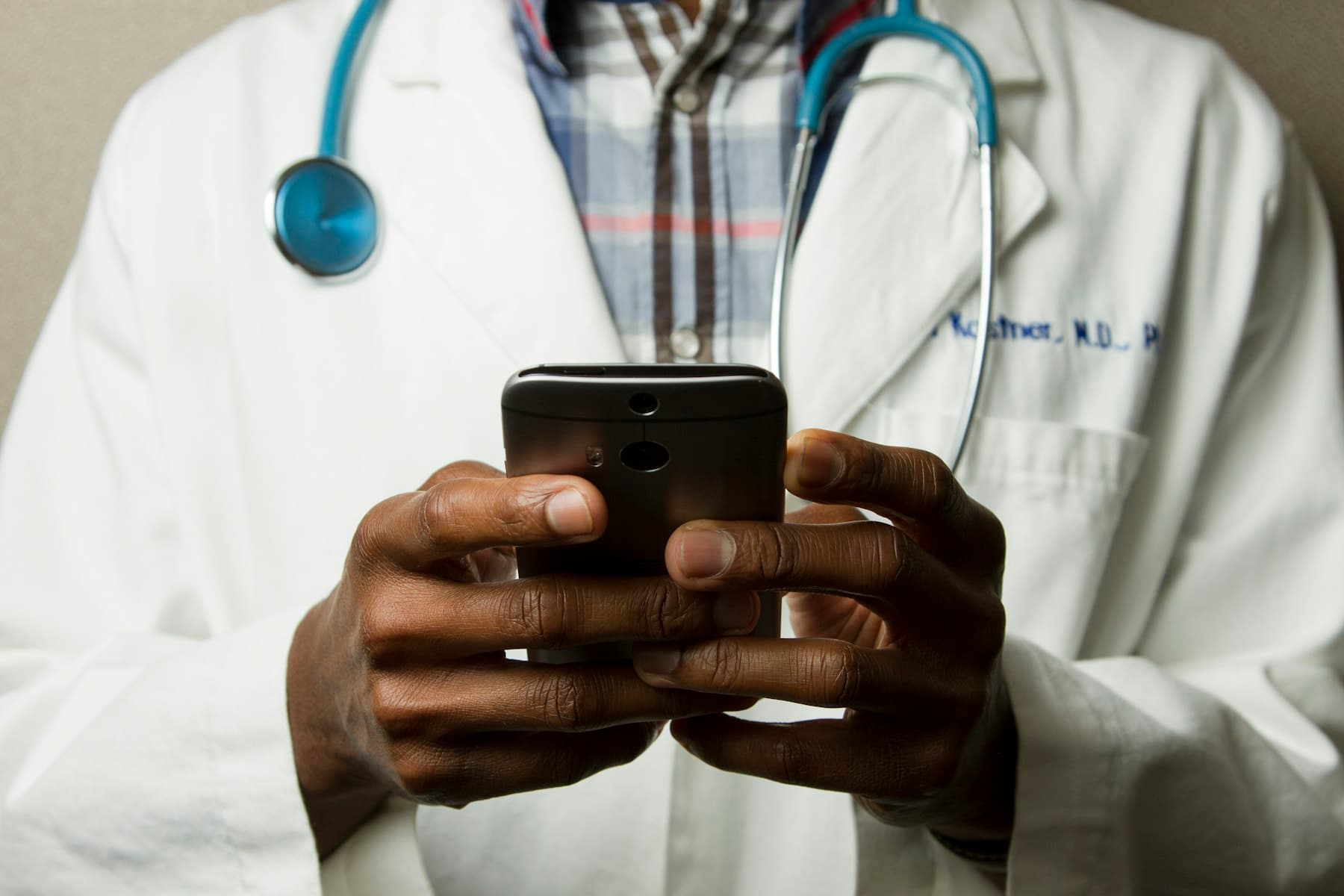 Clinician reviewing care information on a tablet in a hospital